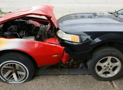Damaged car secured on tow truck – preparing to speak with insurance