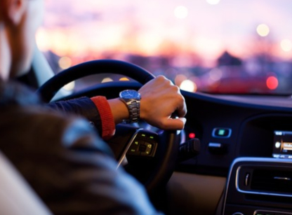 Person's bare feet on car pedals illustrating barefoot driving