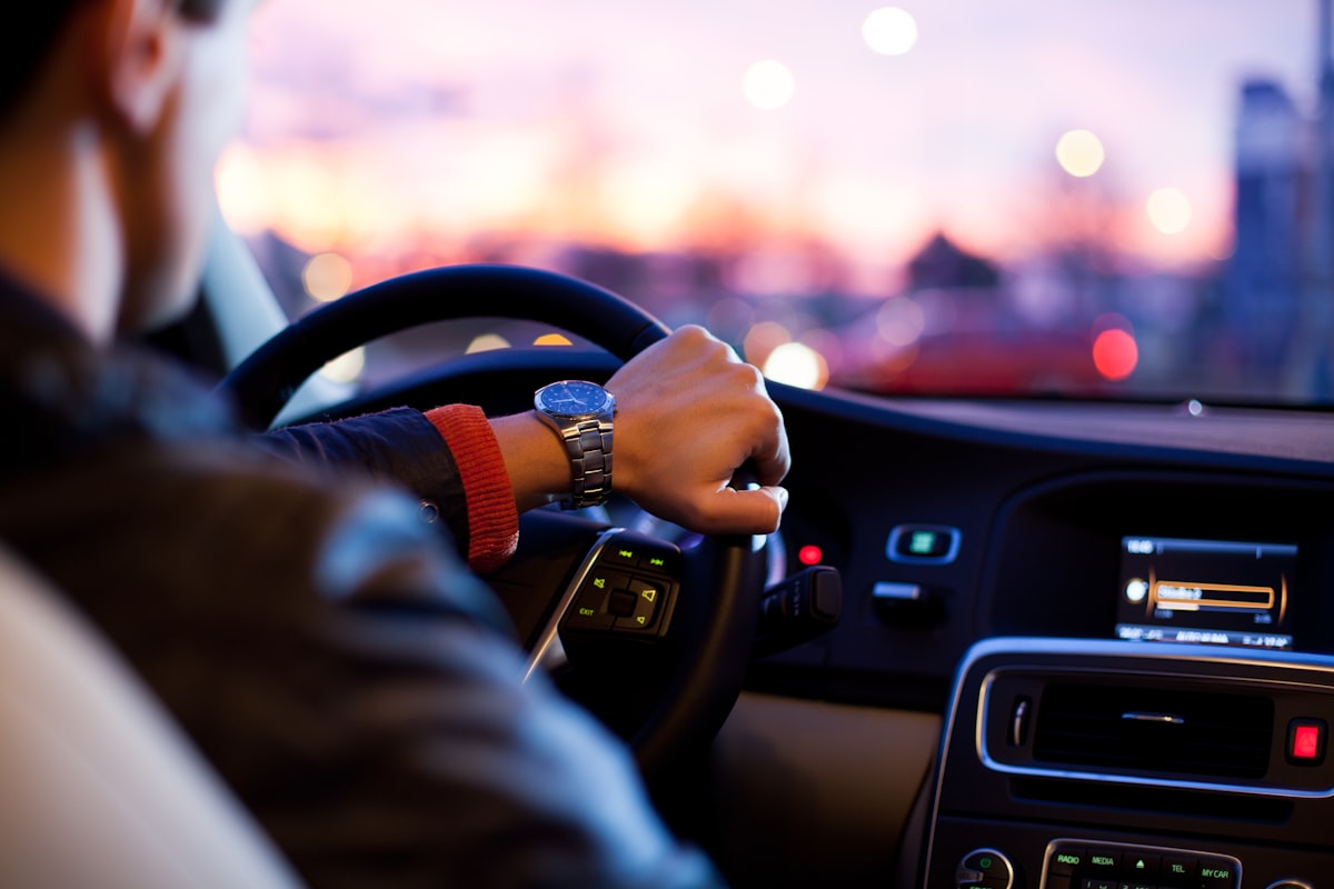 Person's bare feet on car pedals illustrating barefoot driving
